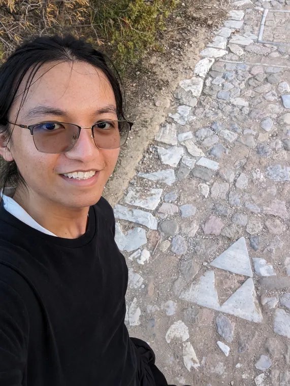 A picture of a triforce shaped rock formation on a pavement