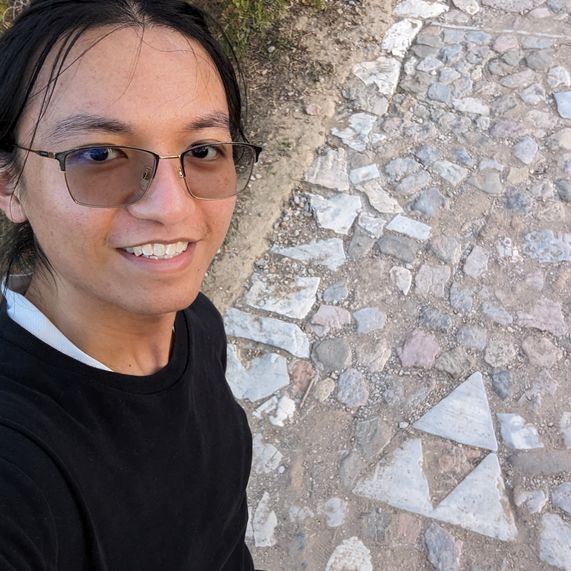 A picture of a triforce shaped rock formation on a pavement